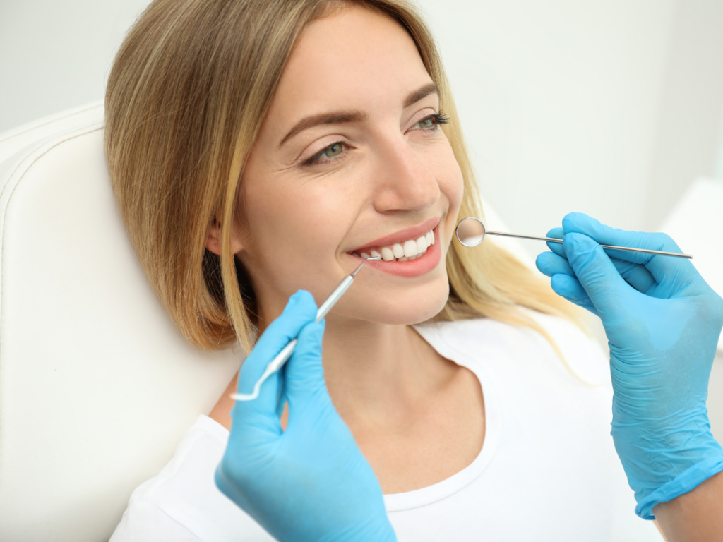 woman receiving cosmetic dentistry services - Maximize Your Dental Benefits Before Year-End